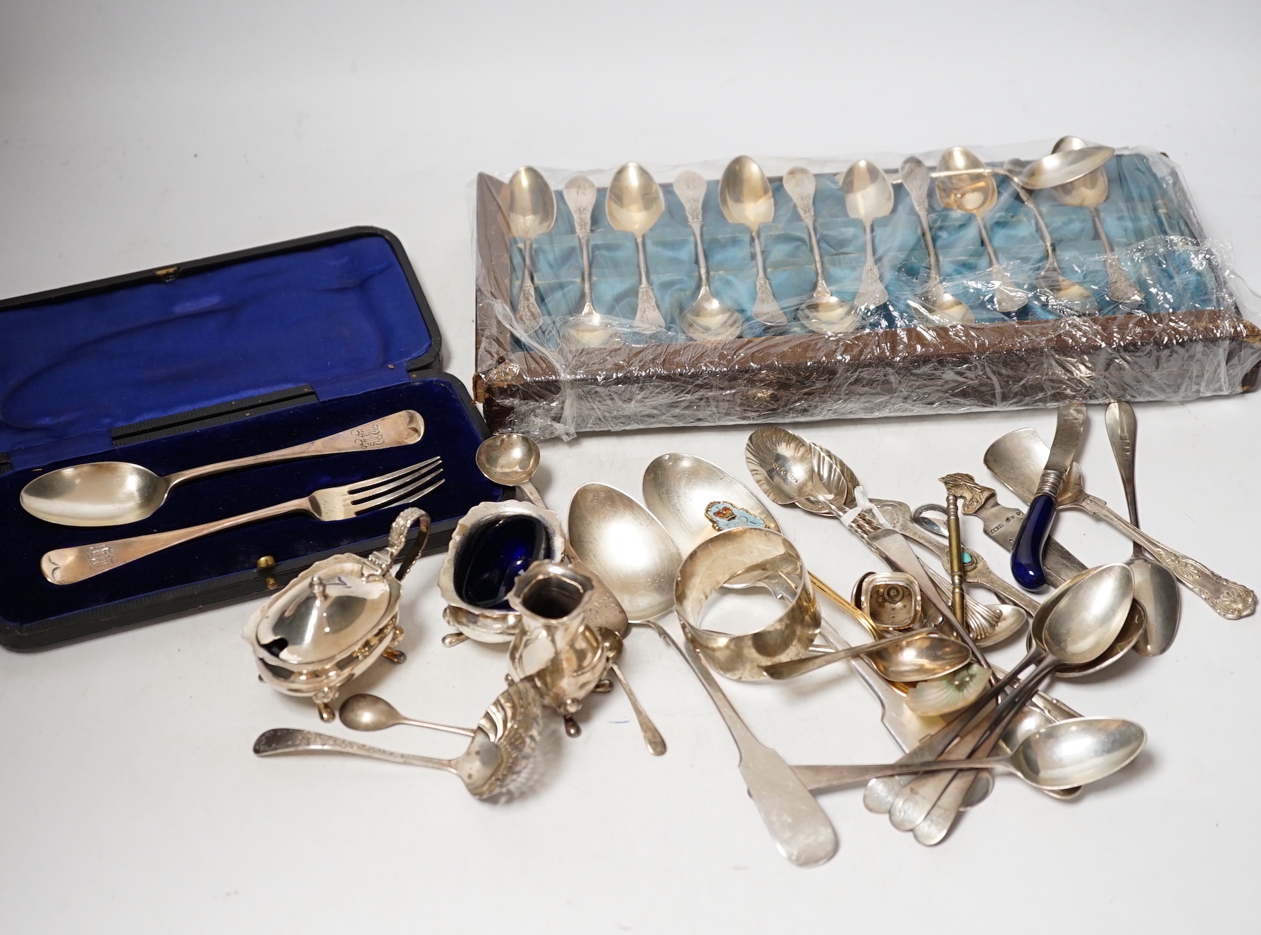 A group of assorted mainly small silver flatware, including 19th century, a small group of sterling spoons, a silver napkin ring and cased silver christening spoon and fork, etc.